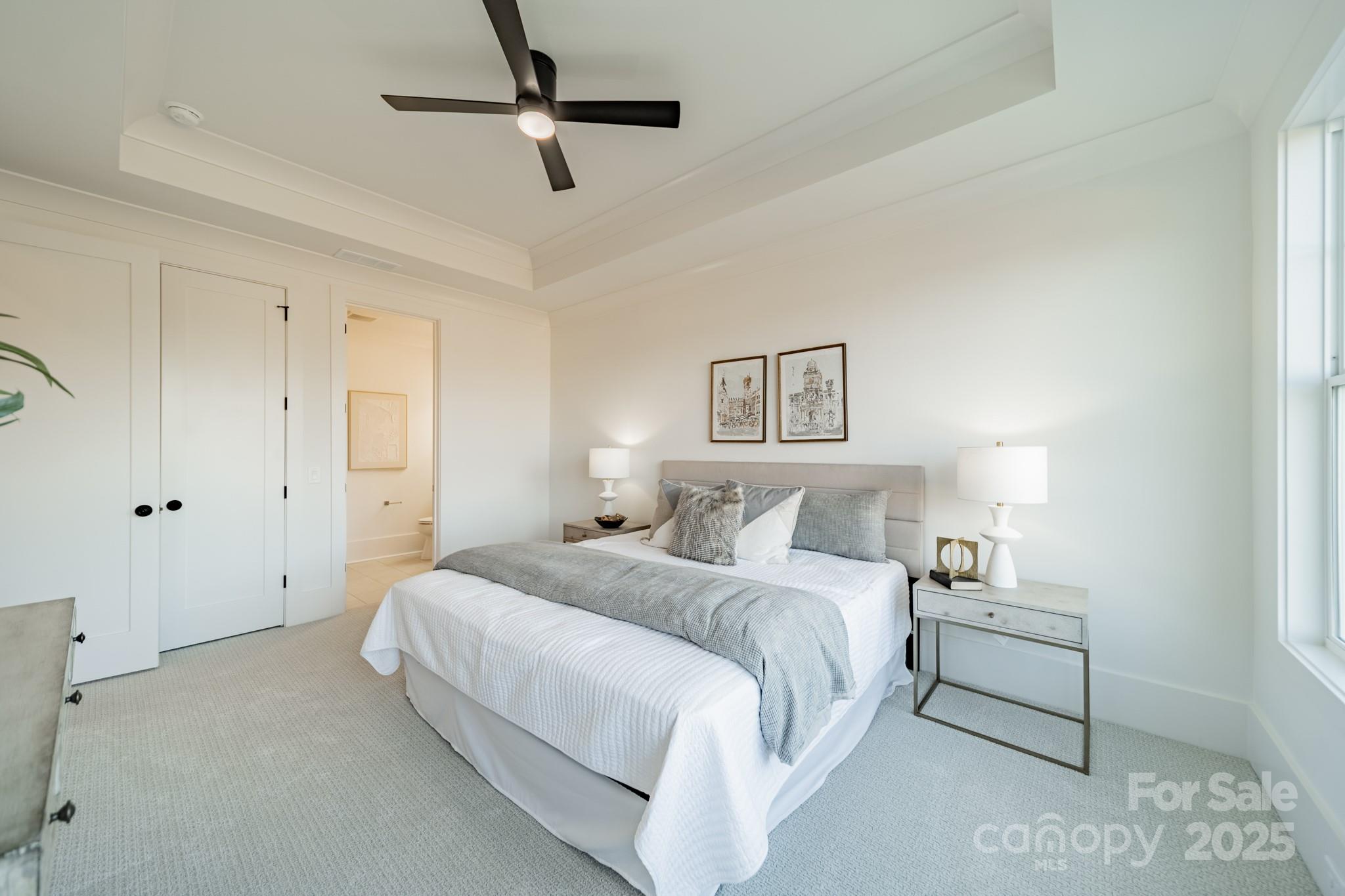 19032 Newburg Hill Road, Unit 23 Davidson, NC 28036 - Photo 29 of 39 a bedroom with a bed and a ceiling fan