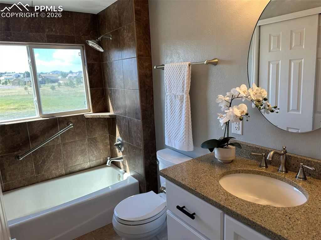 12285 Old Barn Road Elbert, CO 80106 - Photo 19 of 39 a bathroom with a granite countertop sink toilet and shower