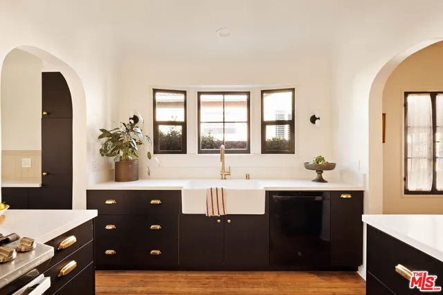 a kitchen with a sink and large window