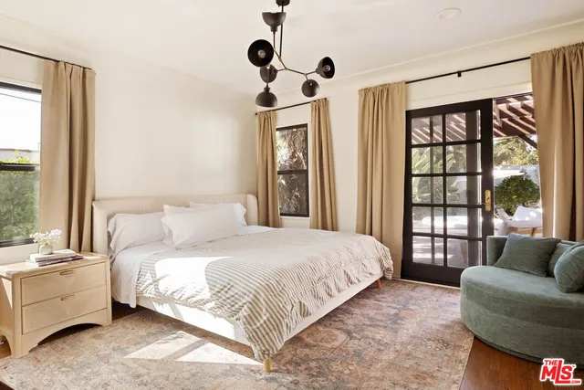 a bedroom with a large bed and a large window