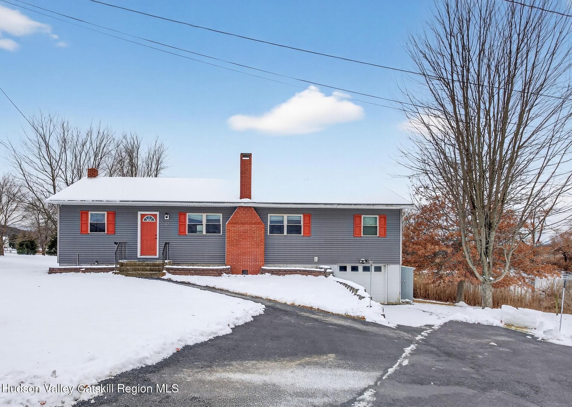67 Picnic Woods Road Clintondale, NY 12515 - Photo 2 of 23 a front view of a house with a yard and covered with snow