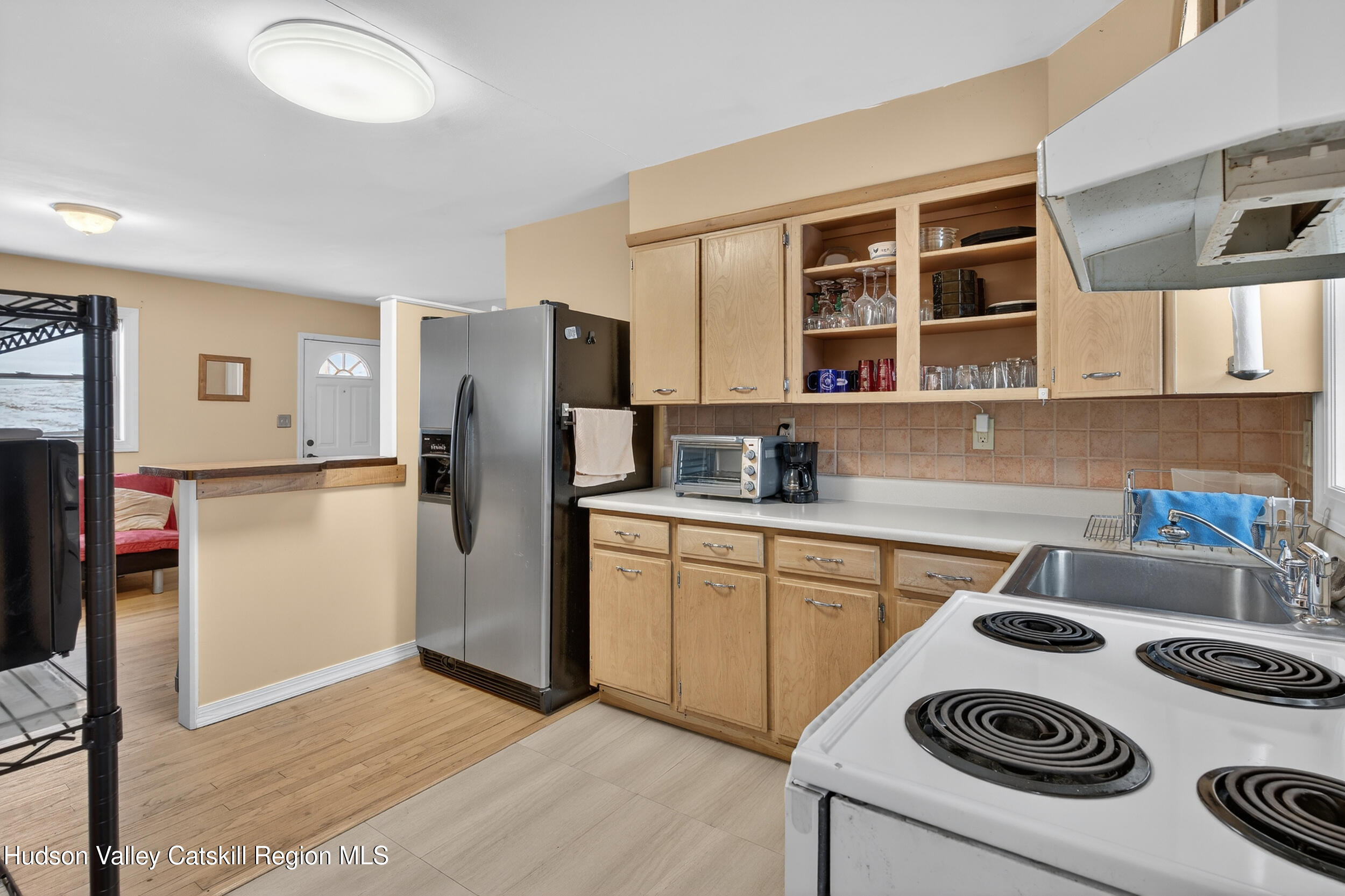 67 Picnic Woods Road Clintondale, NY 12515 - Photo 9 of 23 a kitchen with a refrigerator and a stove top oven