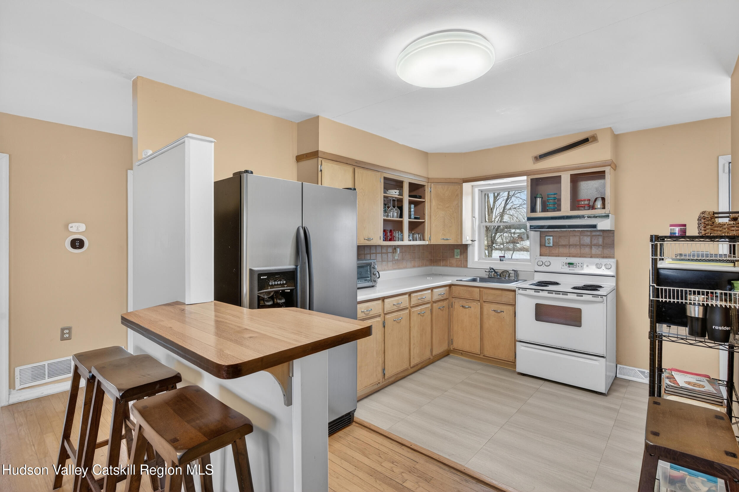 67 Picnic Woods Road Clintondale, NY 12515 - Photo 10 of 23 a kitchen with stainless steel appliances a stove a refrigerator and a dining table