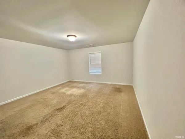 a spacious bathroom with a double vanity sink and a mirror
