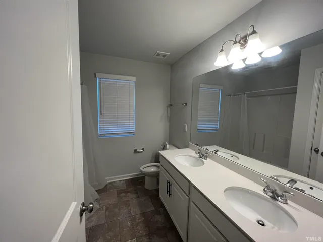 a bathroom with a glass shower door and sink