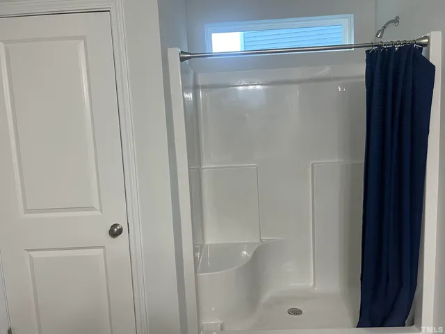a bathroom with a glass shower door