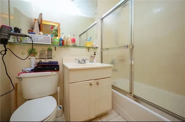 a bathroom with a sink mirror vanity and toilet