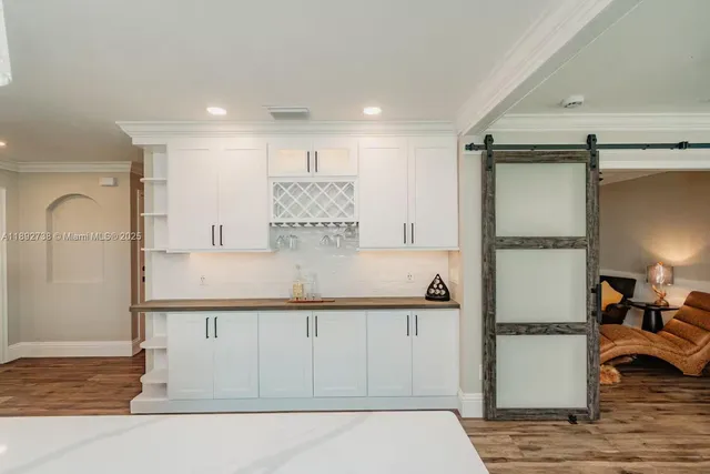 a kitchen with kitchen island a counter top space and cabinets
