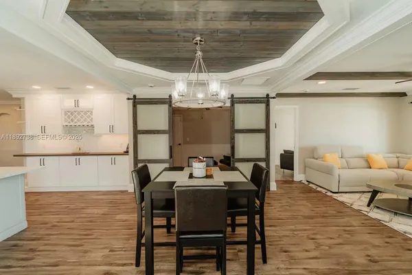 a dining room with furniture and wooden floor
