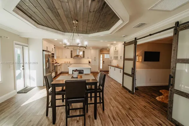 a dining room with furniture and wooden floor