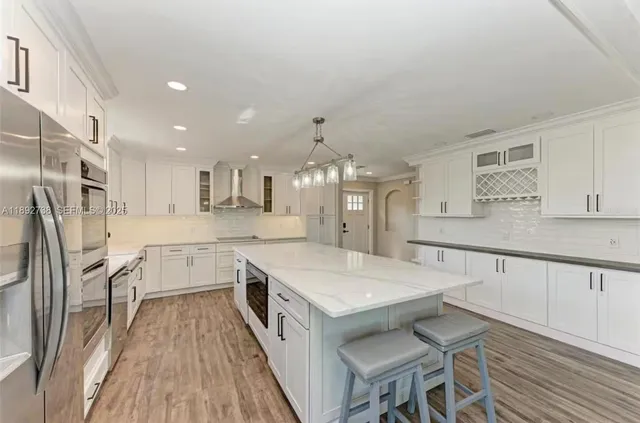 a large white kitchen with a large window