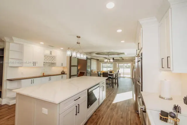 a large white kitchen with a large window