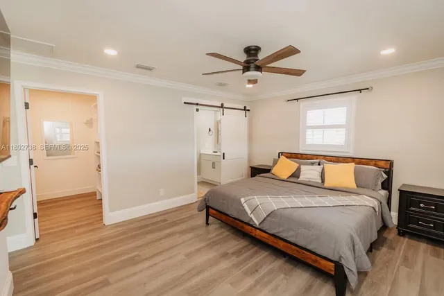 a bedroom with a bed and wooden floor