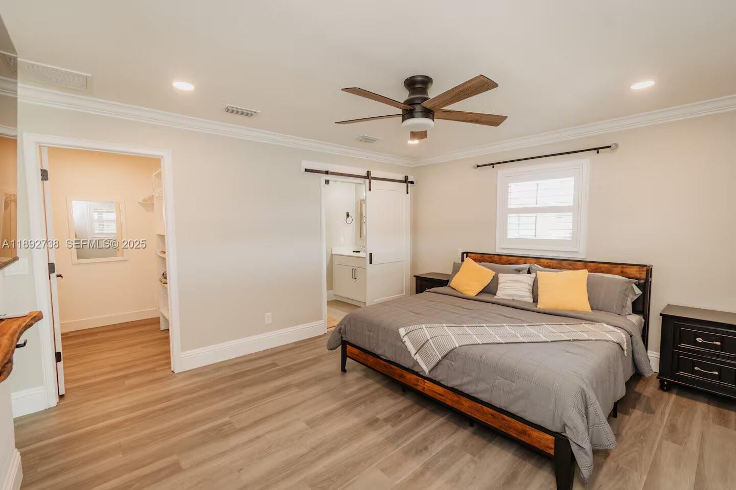 9675 Southwest Anchor, Unit 9674 Arcadia, FL 34269 - Photo 22 of 55 a bedroom with a bed and a chandelier