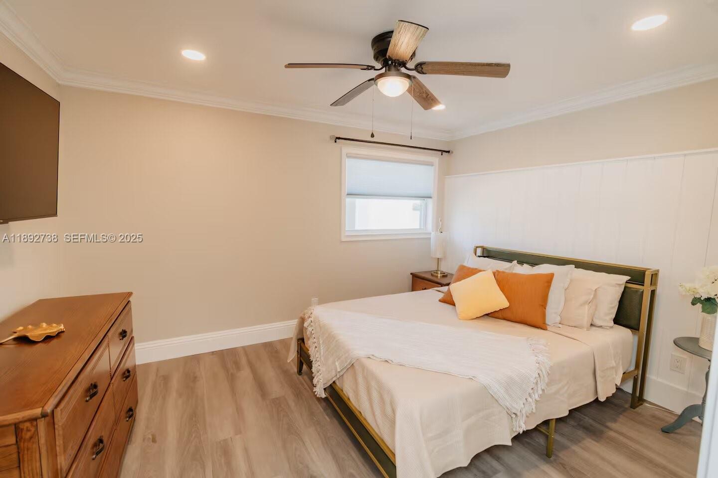 9675 Southwest Anchor, Unit 9674 Arcadia, FL 34269 - Photo 25 of 55 a bedroom with a bed and a chandelier