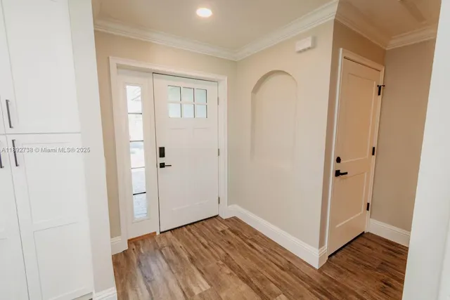 a view of empty room with wooden floor