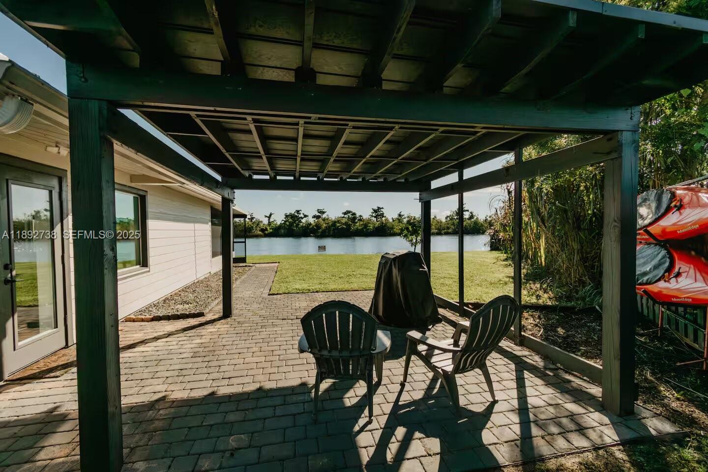 9675 Southwest Anchor, Unit 9674 Arcadia, FL 34269 - Photo 43 of 55 a view of a balcony dining table and chairs with wooden floor