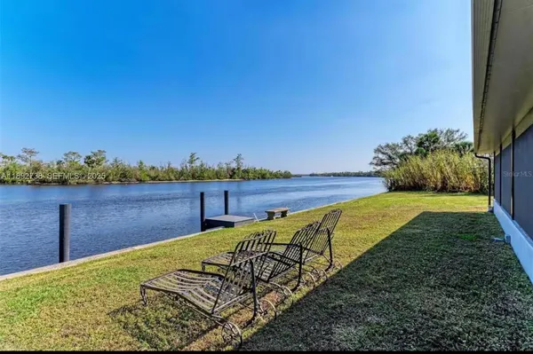 an aerial view of a house with a garden and lake view