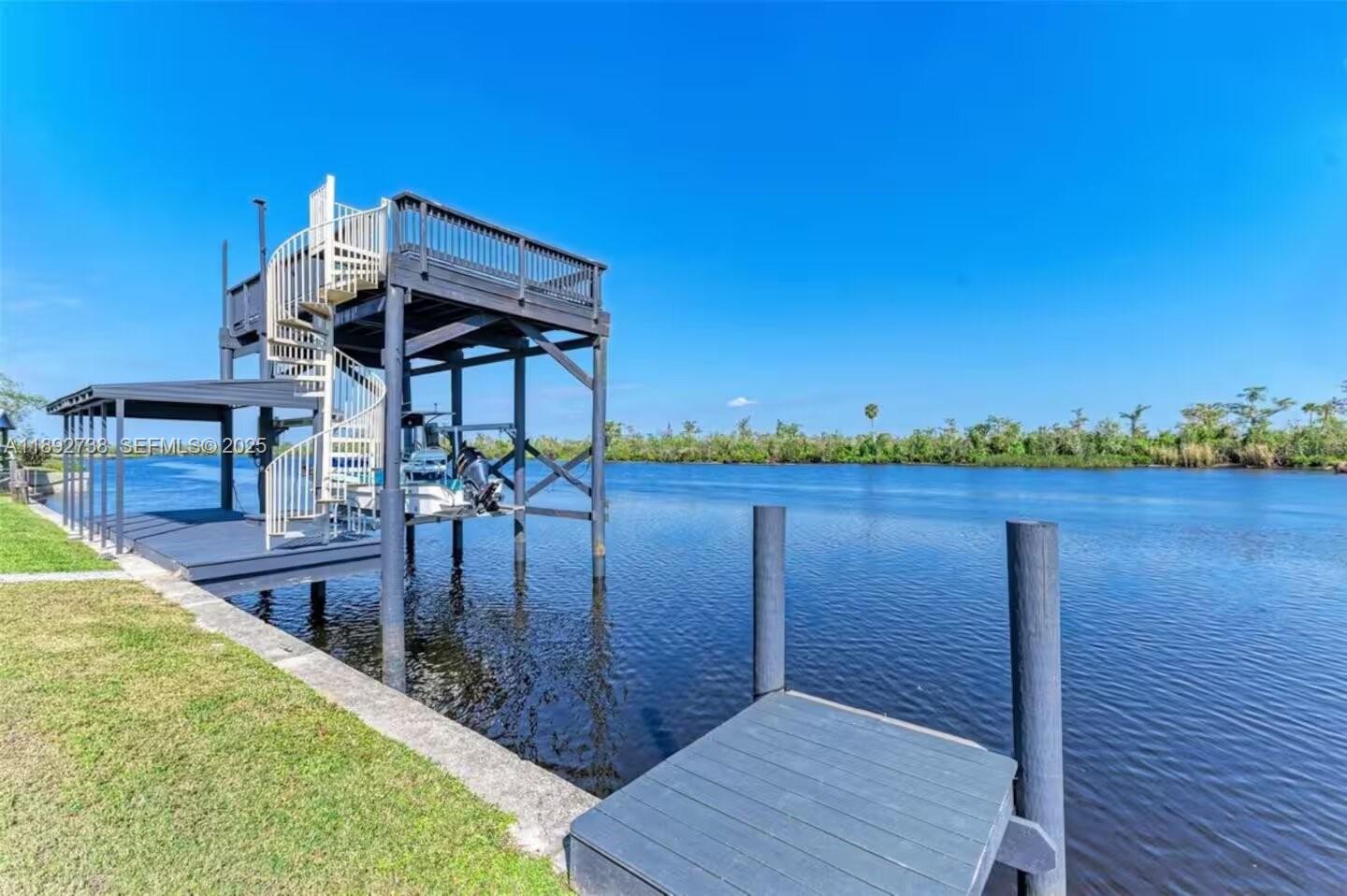 9675 Southwest Anchor, Unit 9674 Arcadia, FL 34269 - Photo 48 of 55 a view of a balcony with lake view and wooden floor