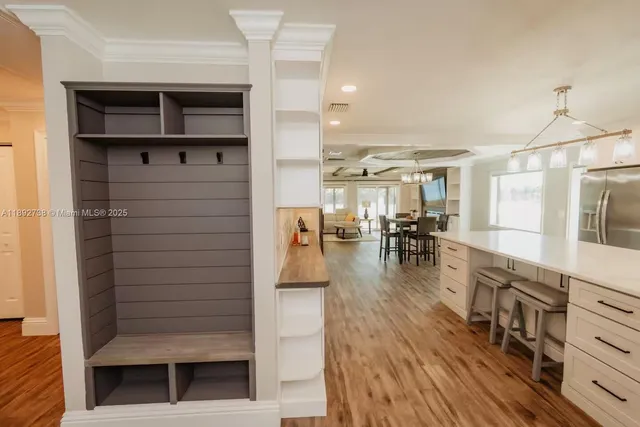 a hallway with wooden floors and fireplace