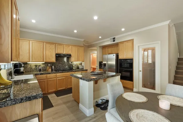 a living room with furniture a fireplace and a large window
