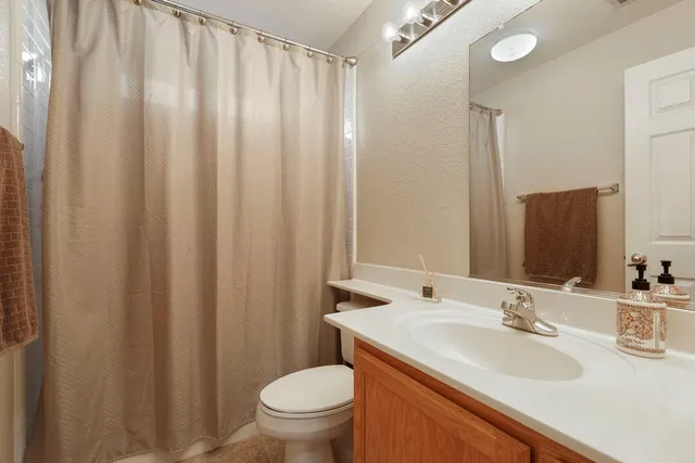 a bedroom with a bed and a table