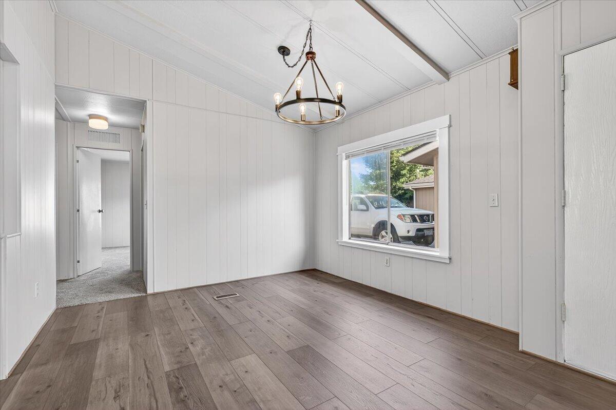 555 Freeman Road, Unit 127 Central Point, OR 97502 - Photo 9 of 32 a view of a room with wooden floor chandelier and window