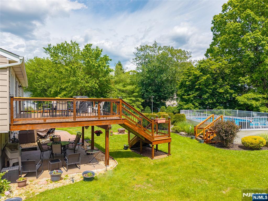 55 Marcia Road Ringwood, NJ 07456 - Photo 30 of 42 a view of a swimming pool with a lounge chair