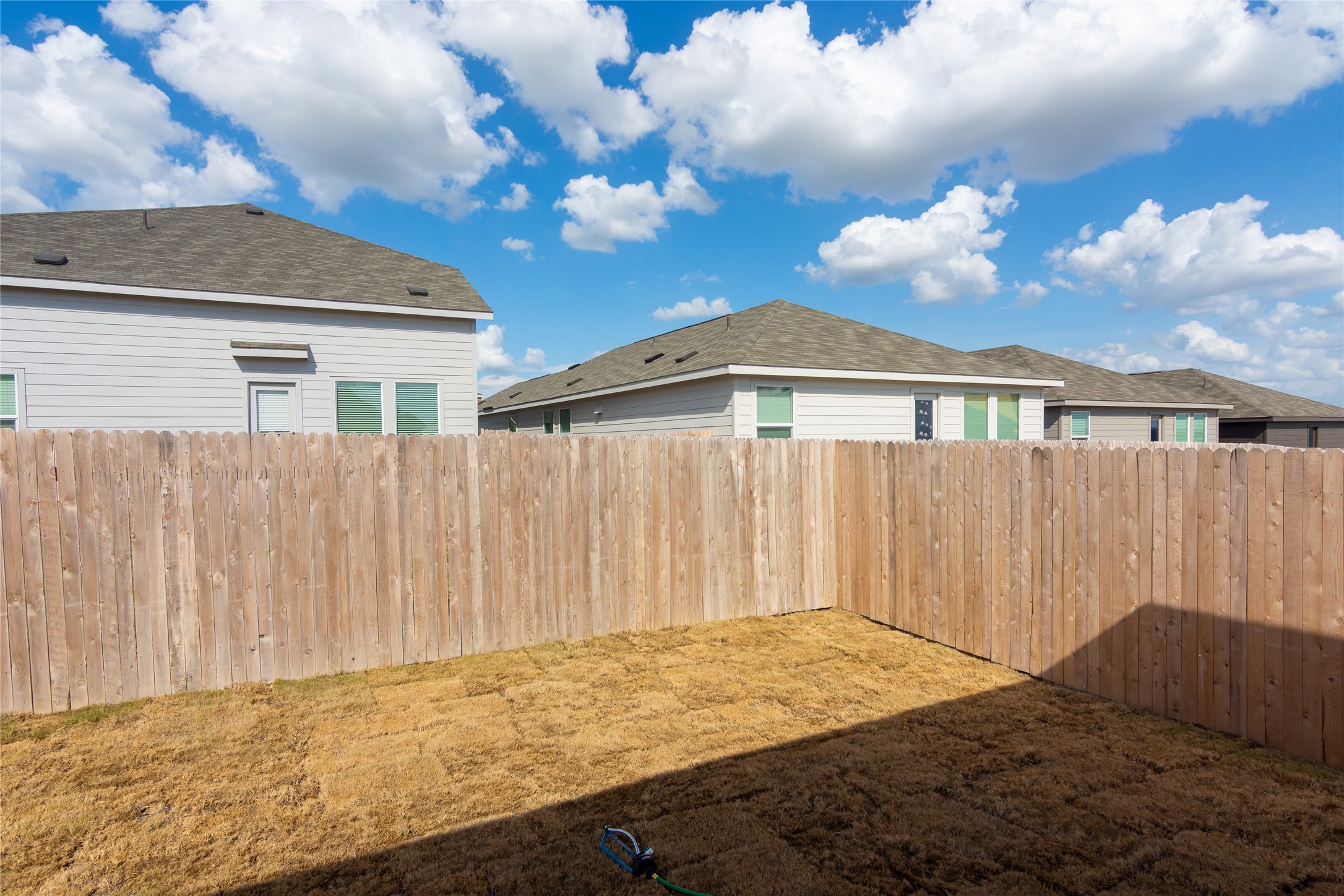 153 Star Packer Lane Jarrell, TX 76537 - Photo 26 of 30 A newly installed wood fence defines the borders of a private yard, offering a tranquil outdoor retreat.