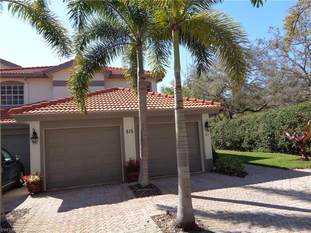 515 Laguna Royale Boulevard, Unit 102 Naples, FL 34119 - Photo 1 of 28 View of front facade with stucco siding, an attached garage, a tiled roof, and decorative driveway