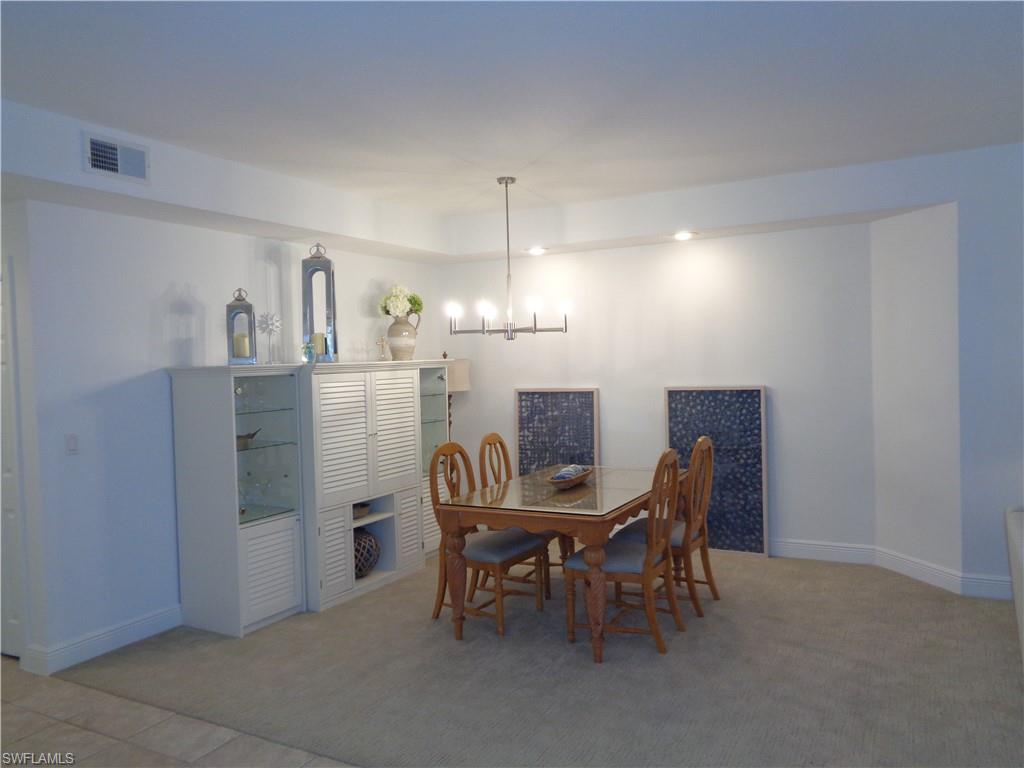 515 Laguna Royale Boulevard, Unit 102 Naples, FL 34119 - Photo 12 of 28 Dining space with baseboards, visible vents, and carpet