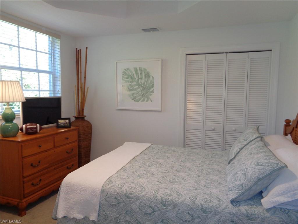 515 Laguna Royale Boulevard, Unit 102 Naples, FL 34119 - Photo 14 of 28 Bedroom with a closet and visible vents