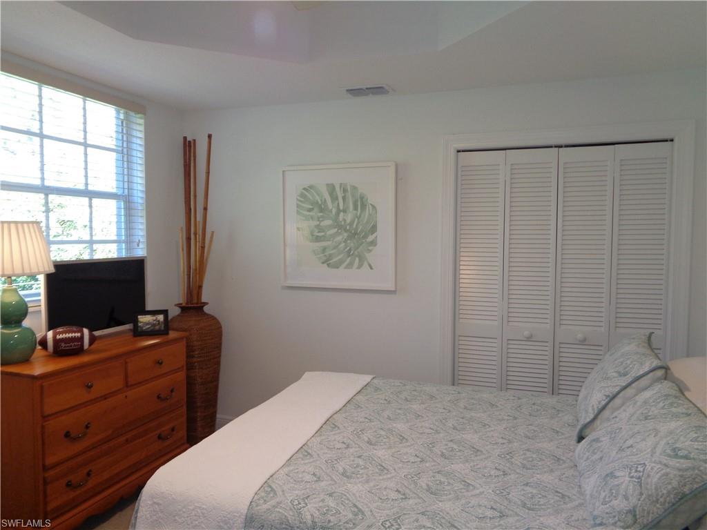 515 Laguna Royale Boulevard, Unit 102 Naples, FL 34119 - Photo 15 of 28 Bedroom with visible vents and a closet