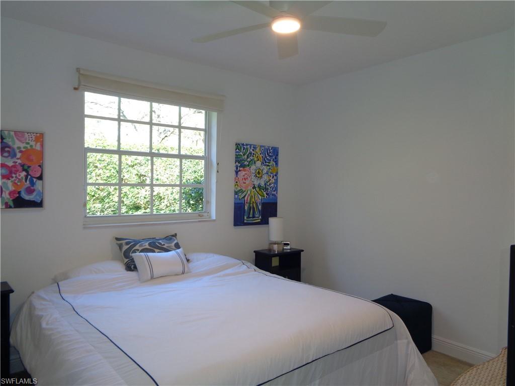 515 Laguna Royale Boulevard, Unit 102 Naples, FL 34119 - Photo 17 of 28 Bedroom featuring baseboards and ceiling fan