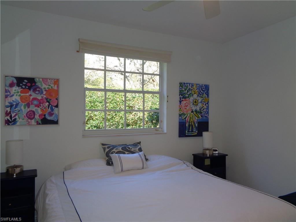 515 Laguna Royale Boulevard, Unit 102 Naples, FL 34119 - Photo 18 of 28 Bedroom with a ceiling fan