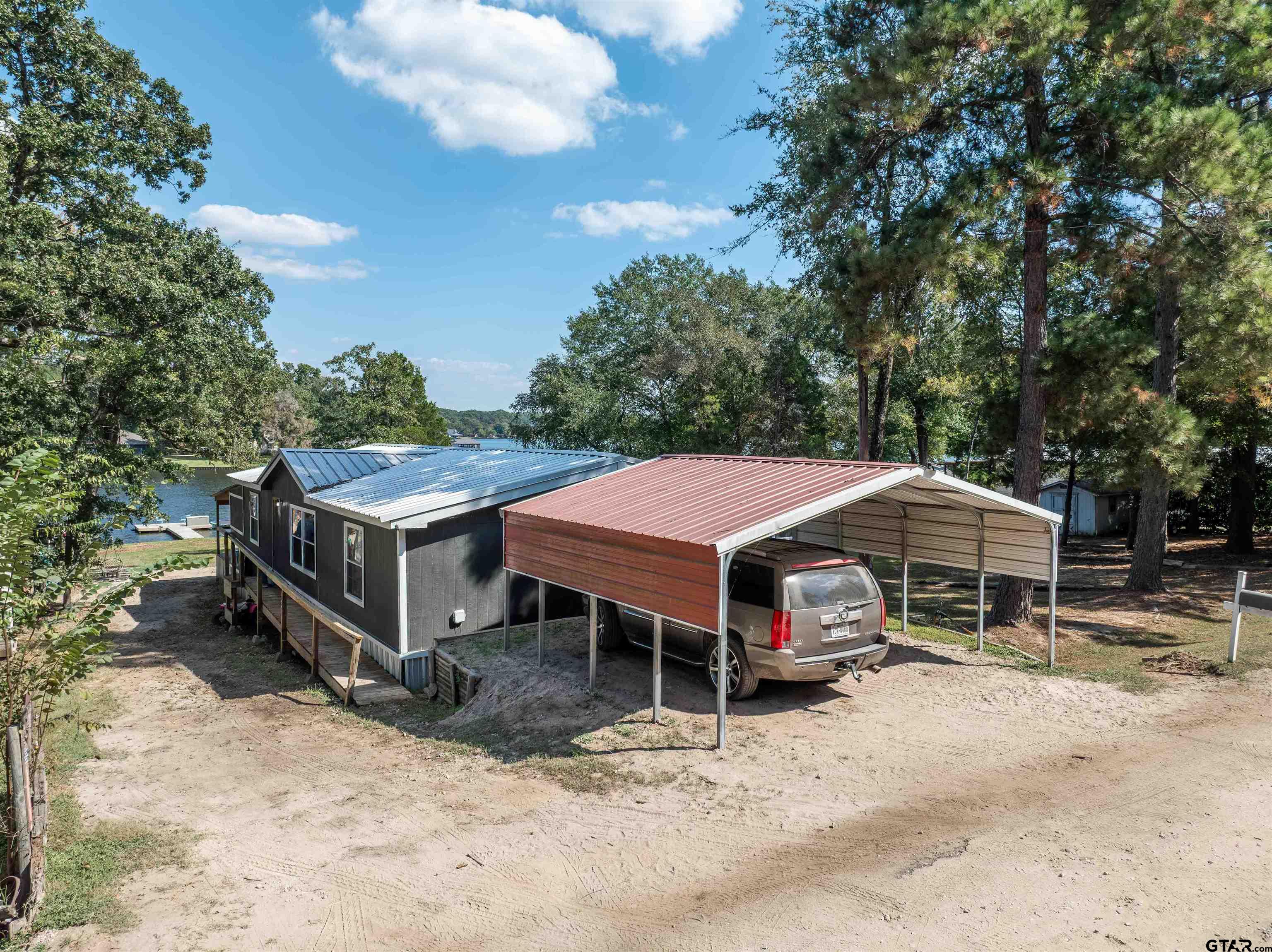 682 Dogwood Trail Murchison, TX 75778 - Photo 11 of 48 a patio with a table and chairs under an umbrella