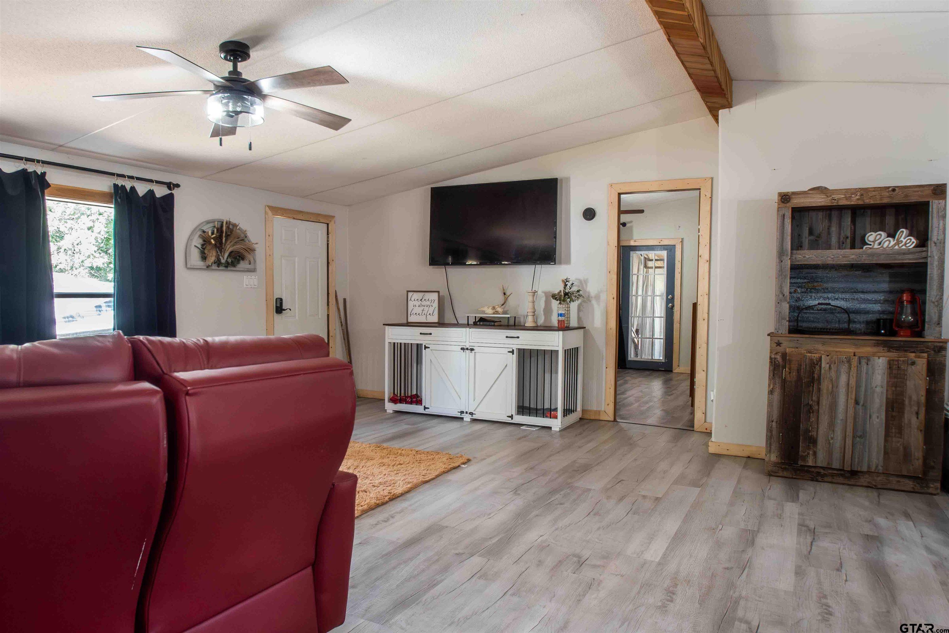 682 Dogwood Trail Murchison, TX 75778 - Photo 14 of 48 a living room with furniture and a flat screen tv