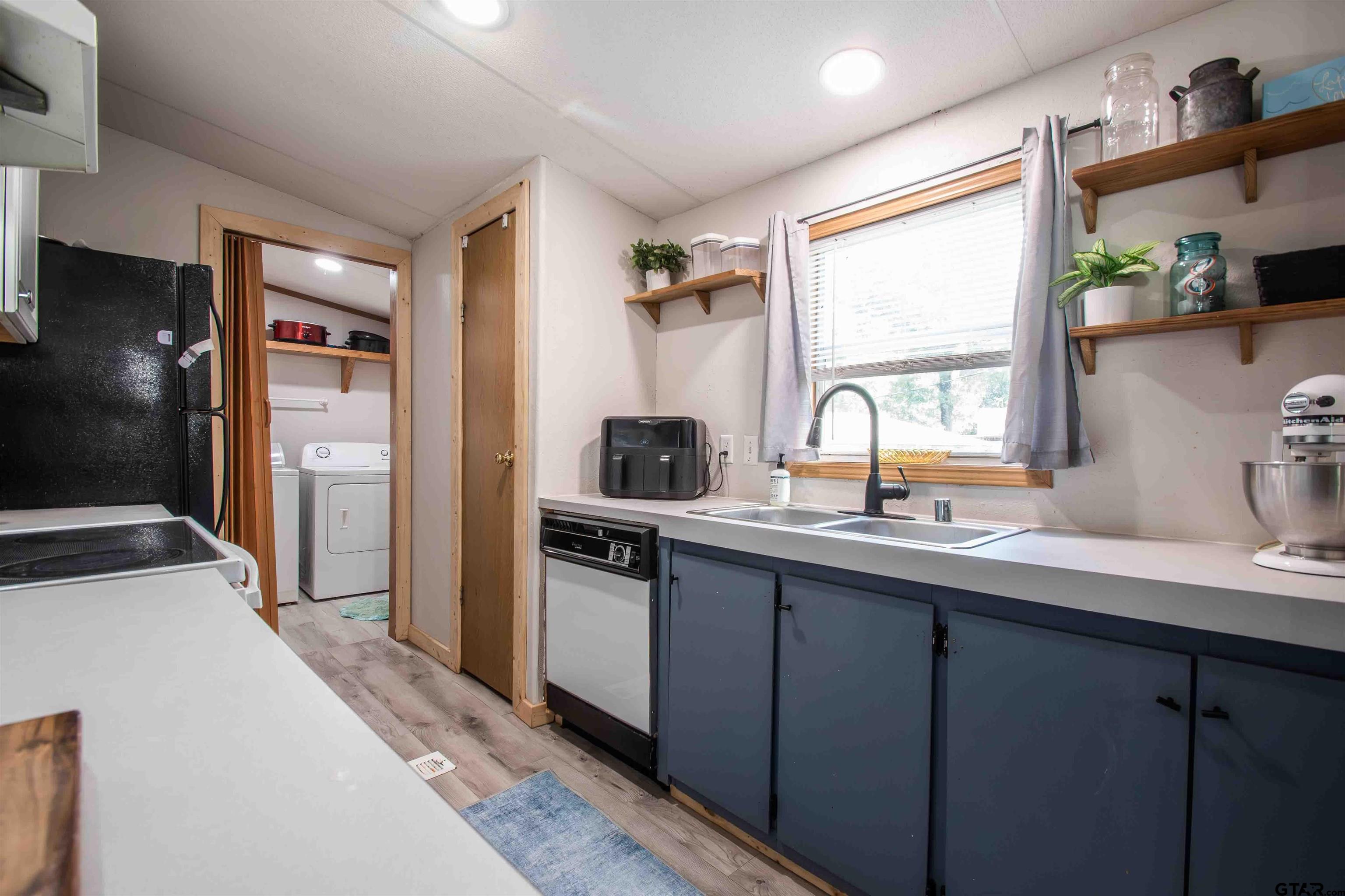 682 Dogwood Trail Murchison, TX 75778 - Photo 18 of 48 a kitchen with a sink stove and refrigerator