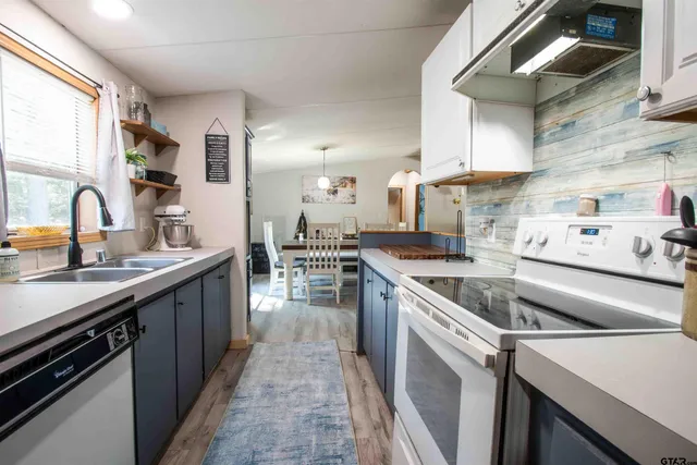 a bedroom with bed and a chandelier
