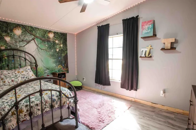 a kitchen with stainless steel appliances kitchen island granite countertop a refrigerator a stove a microwave oven a sink with island and chairs