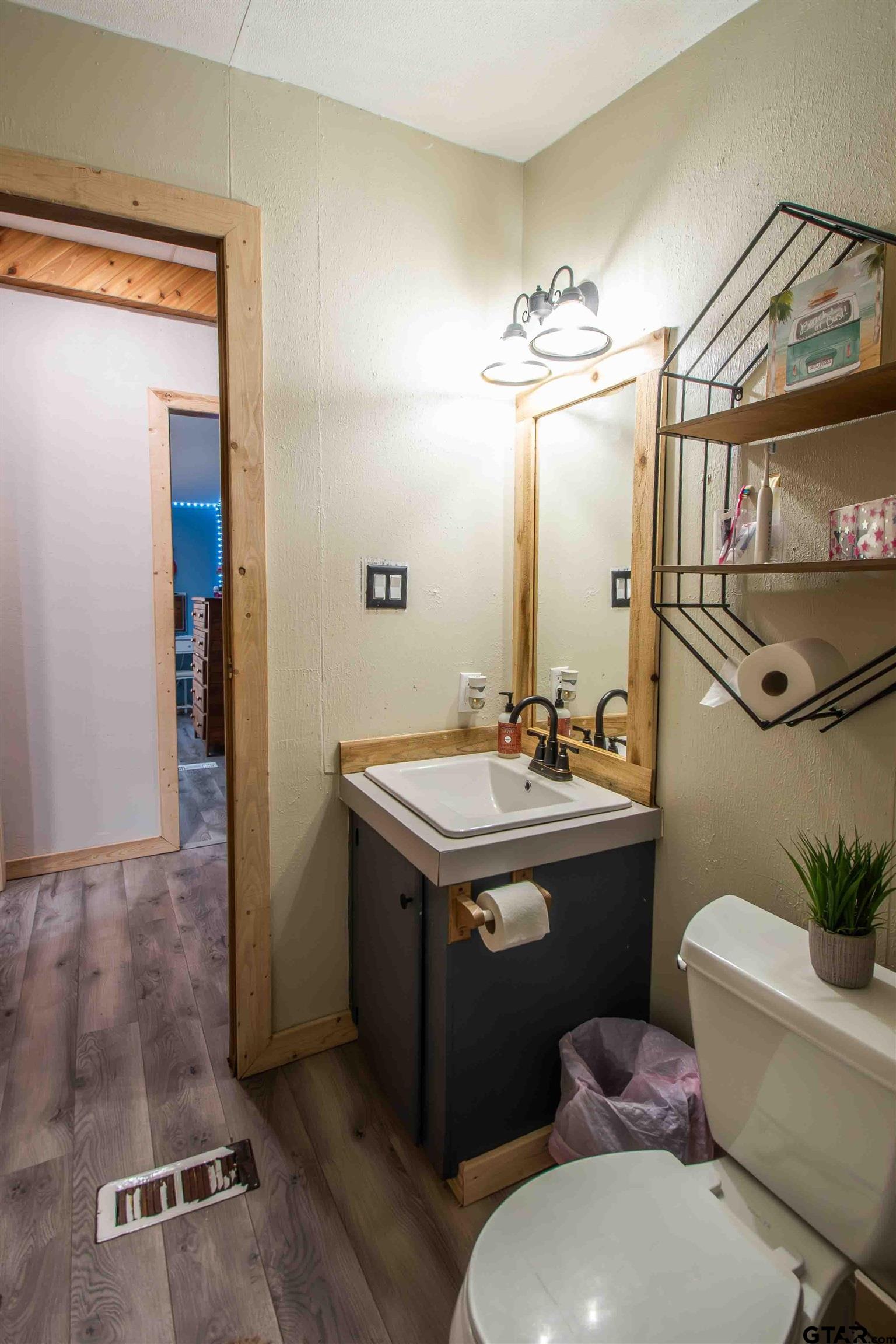 682 Dogwood Trail Murchison, TX 75778 - Photo 28 of 48 a bathroom with a sink a toilet and mirror