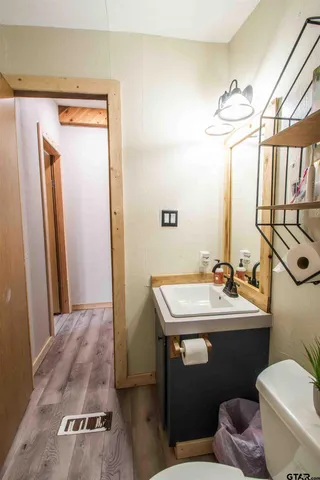 a bedroom with a bed dresser and a window