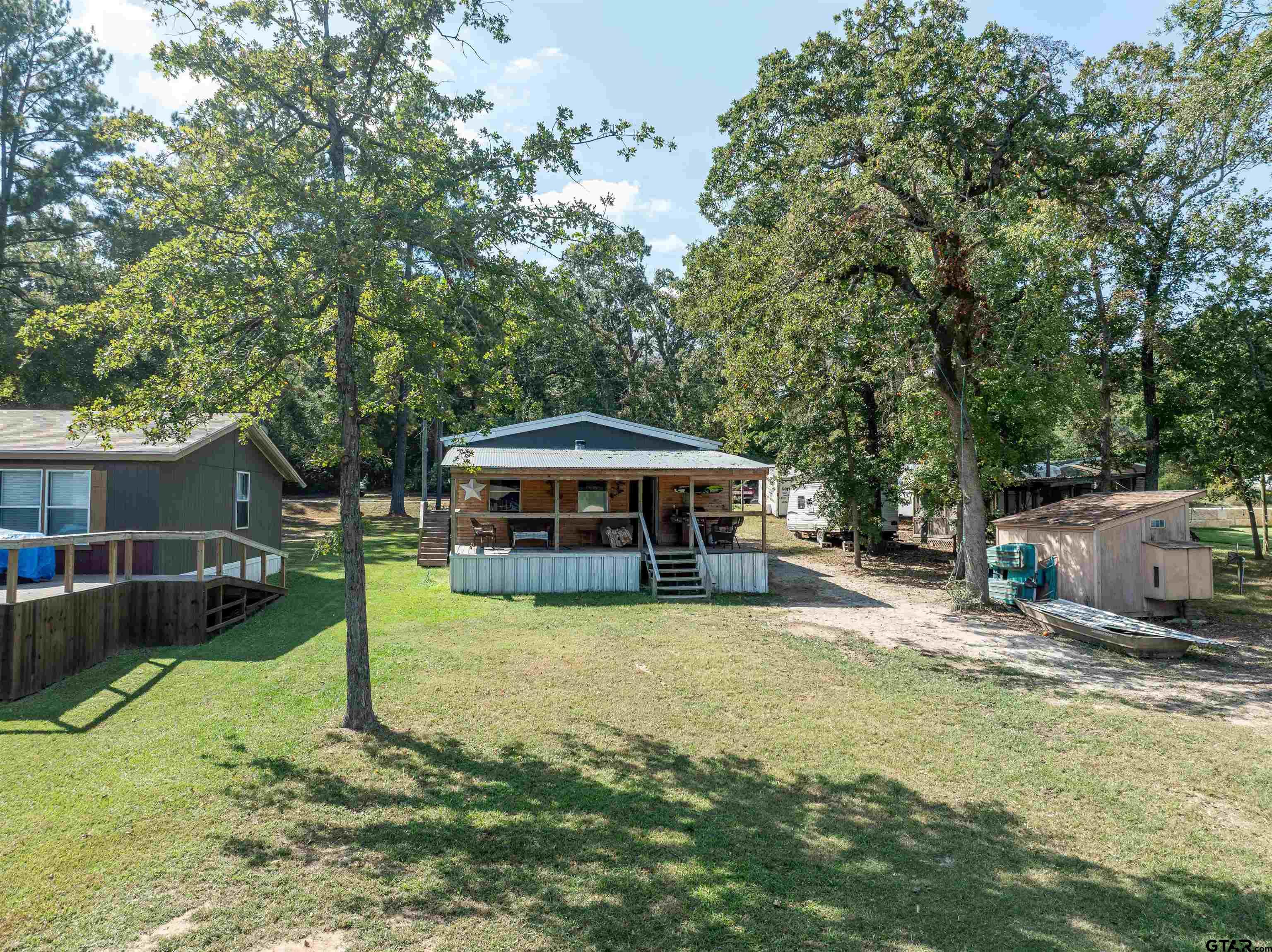 682 Dogwood Trail Murchison, TX 75778 - Photo 3 of 48 a view of a house with a yard patio and fire pit