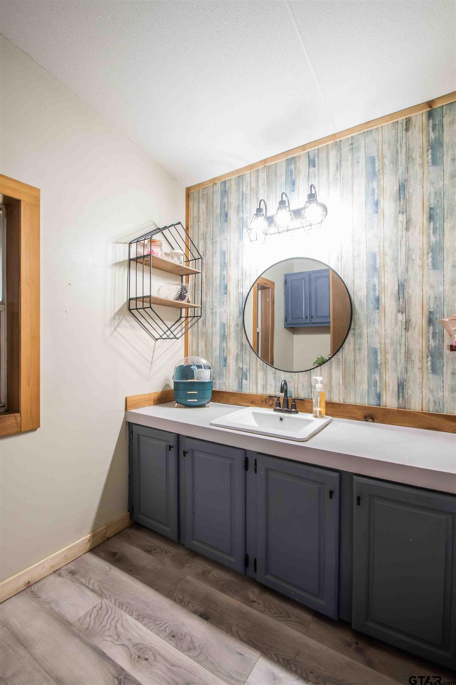 682 Dogwood Trail Murchison, TX 75778 - Photo 37 of 48 a bathroom with a sink and a mirror