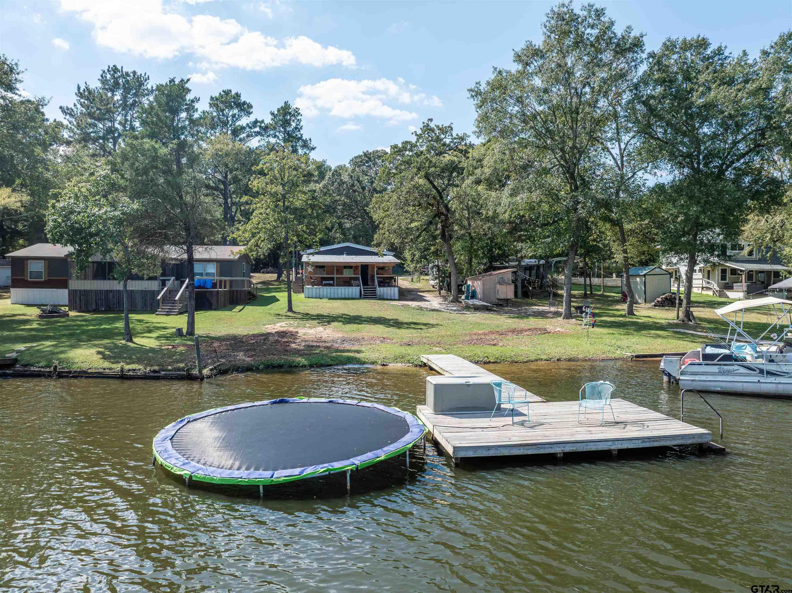 682 Dogwood Trail Murchison, TX 75778 - Photo 10 of 48 a view of a swimming pool with a patio