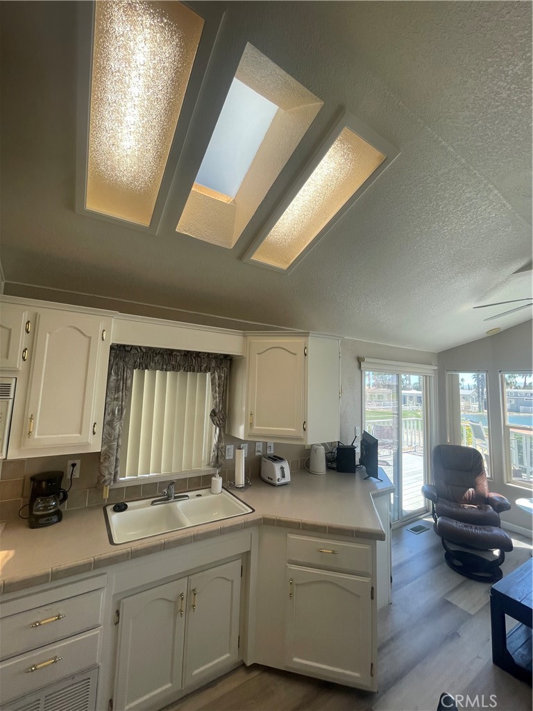 74711 Dillon Road, Unit 69 Desert Hot Springs, CA 92241 - Photo 6 of 18 a kitchen with a sink and cabinets