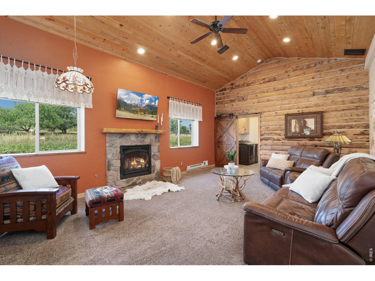 54 Rist View Road Bellvue, CO 80512 - Photo 12 of 50 Living Room with gas fireplace, pine log walls and pine beetle kill ceilings!