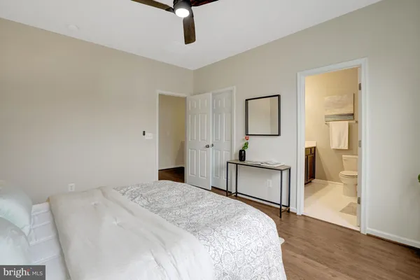 a bedroom with a bed and wooden floor