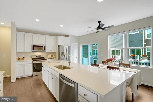 a large white kitchen with cabinets