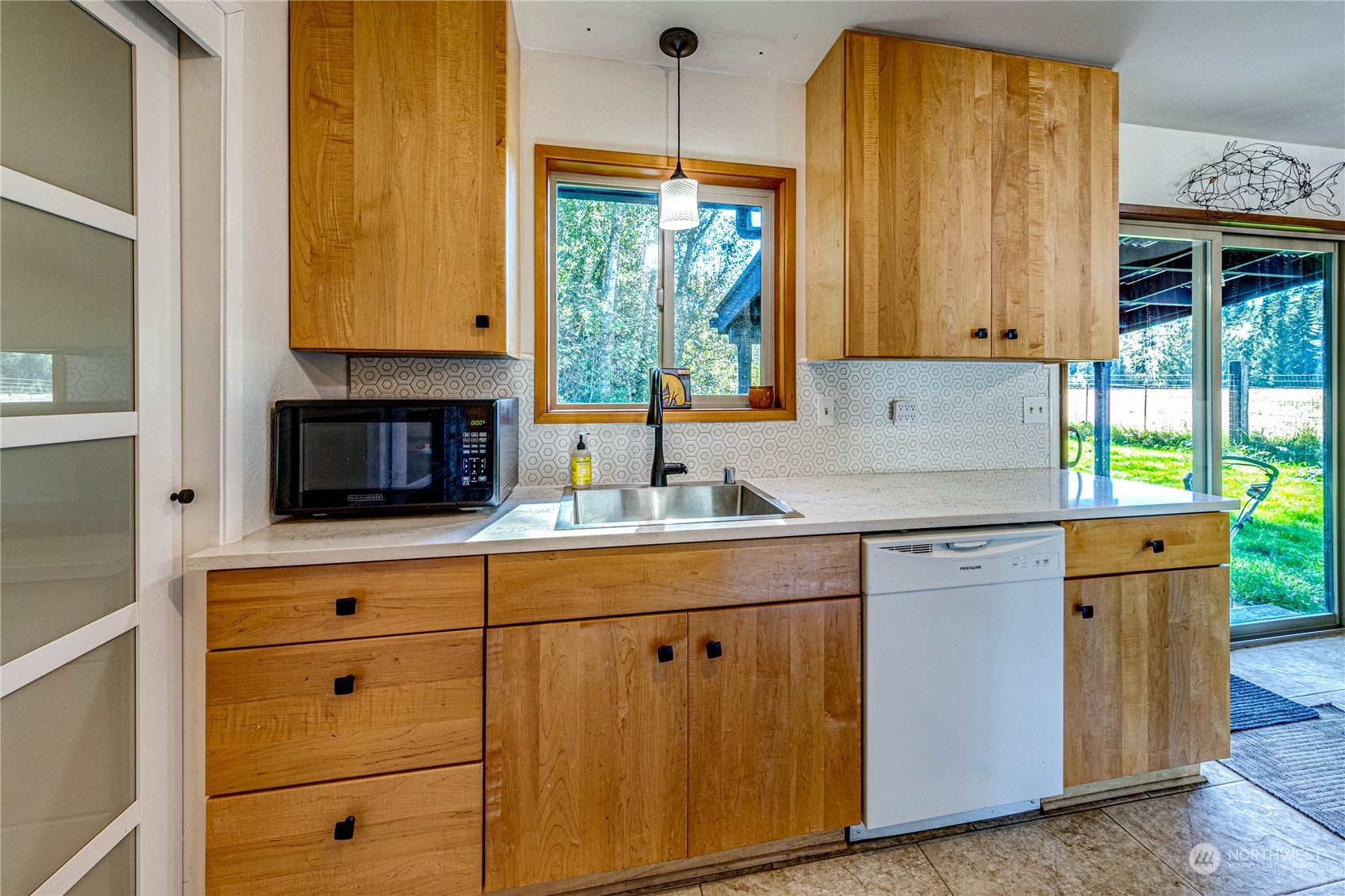 283 Schmitt Road Port Angeles, WA 98363 - Photo 12 of 40 a kitchen with stainless steel appliances granite countertop white cabinets sink and a large window